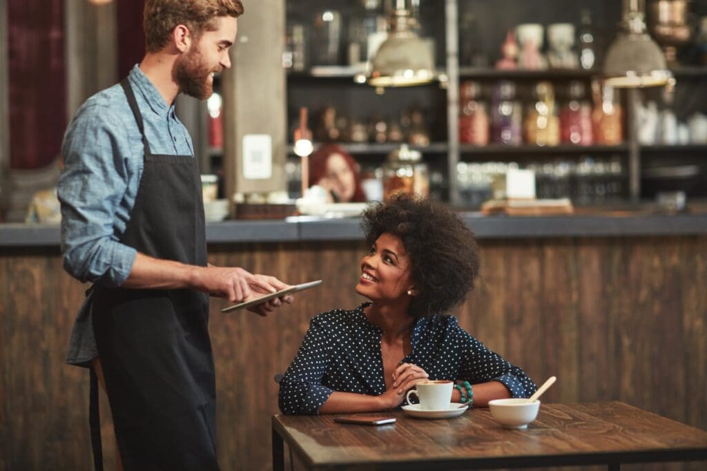 Hospitality worker helping a customer in a restaurant